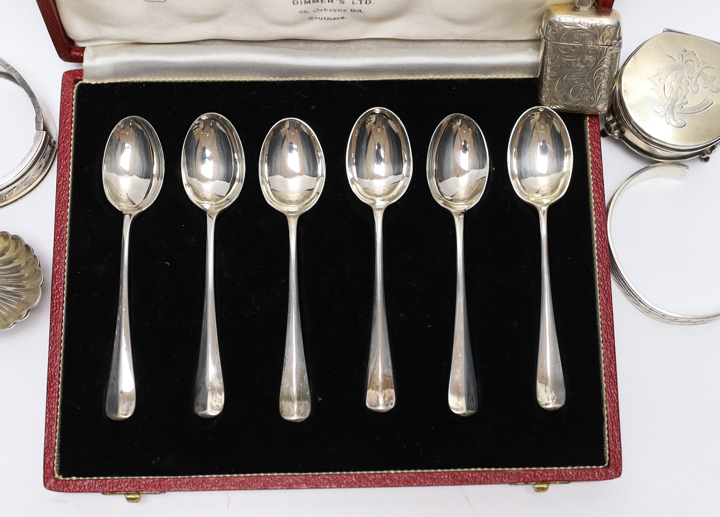 A modern silver caddy spoon, a small Edwardian silver mounted trinket box, a silver vesta case, a Victorian silver bangle and a 925 bangle and a cased set of six silver 'Hallmark' spoons.